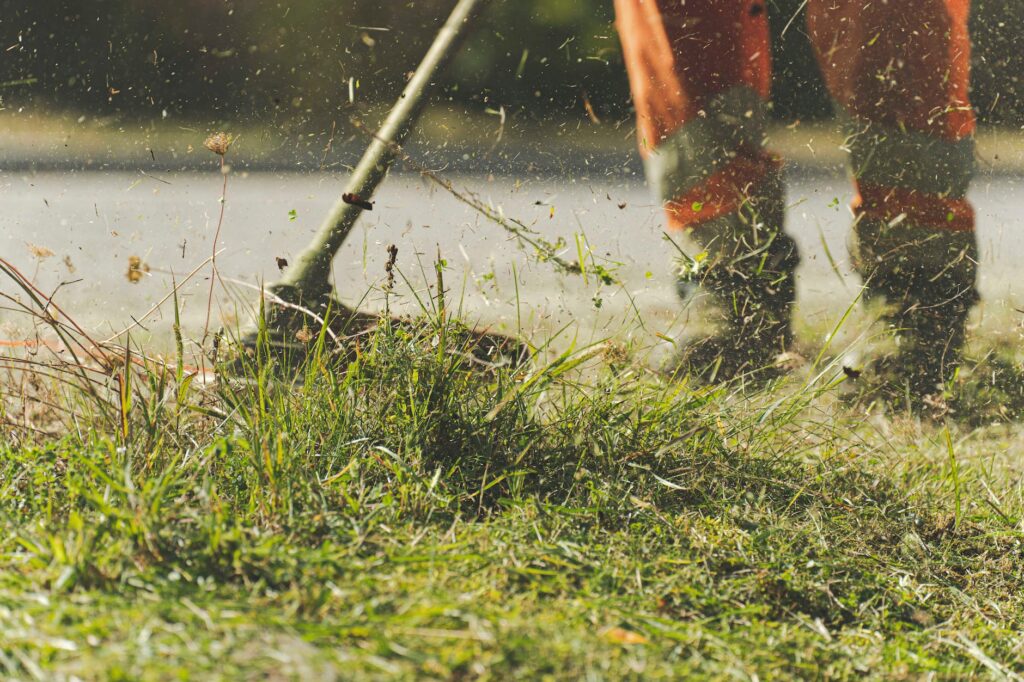 person using lawn mower